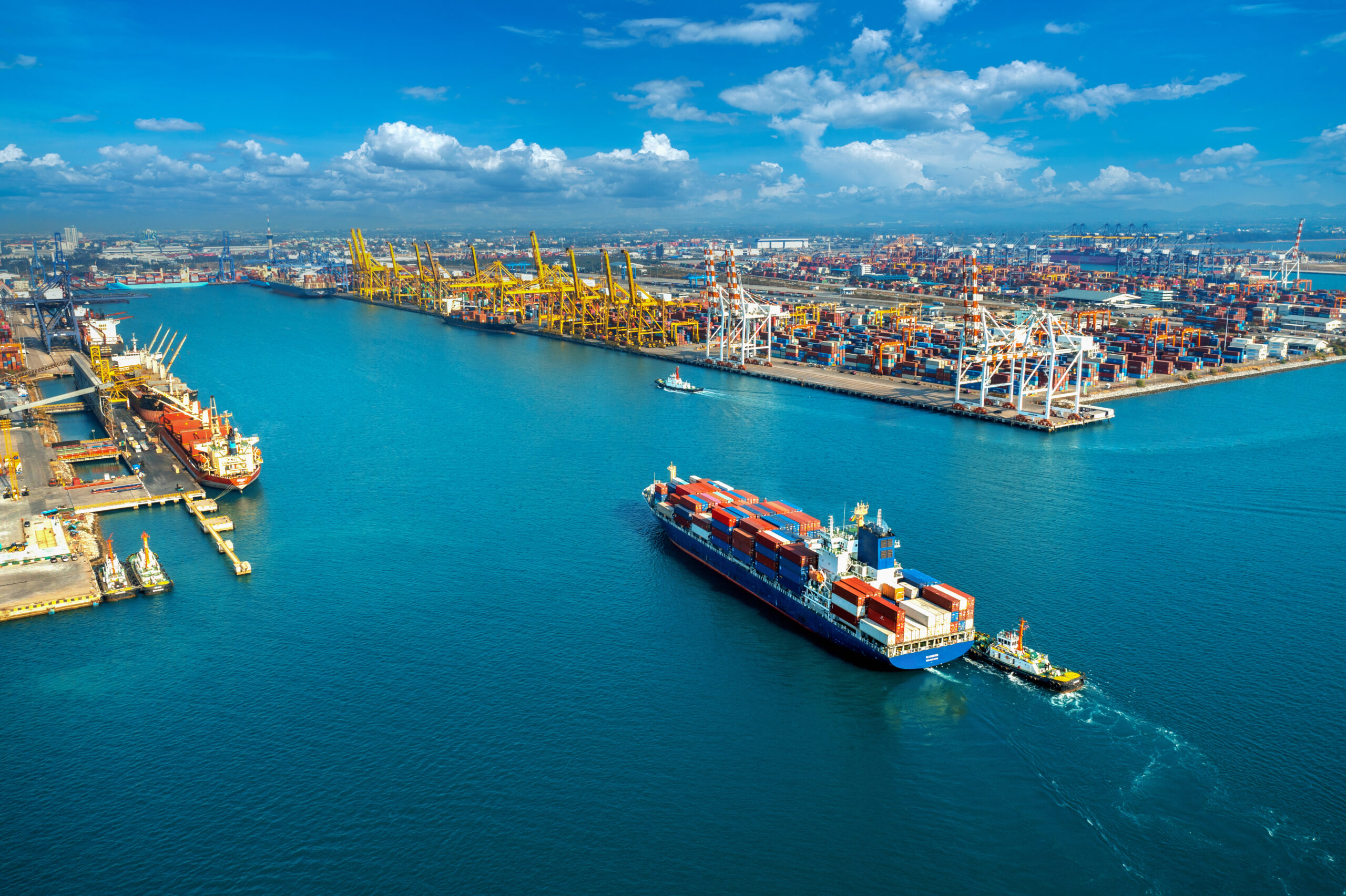 Aerial view of cargo ship and cargo container in harbour.