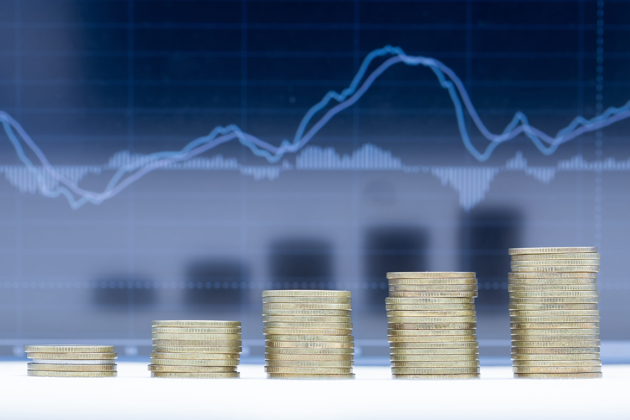 A stack of five rows of coins with graph dark blue background.