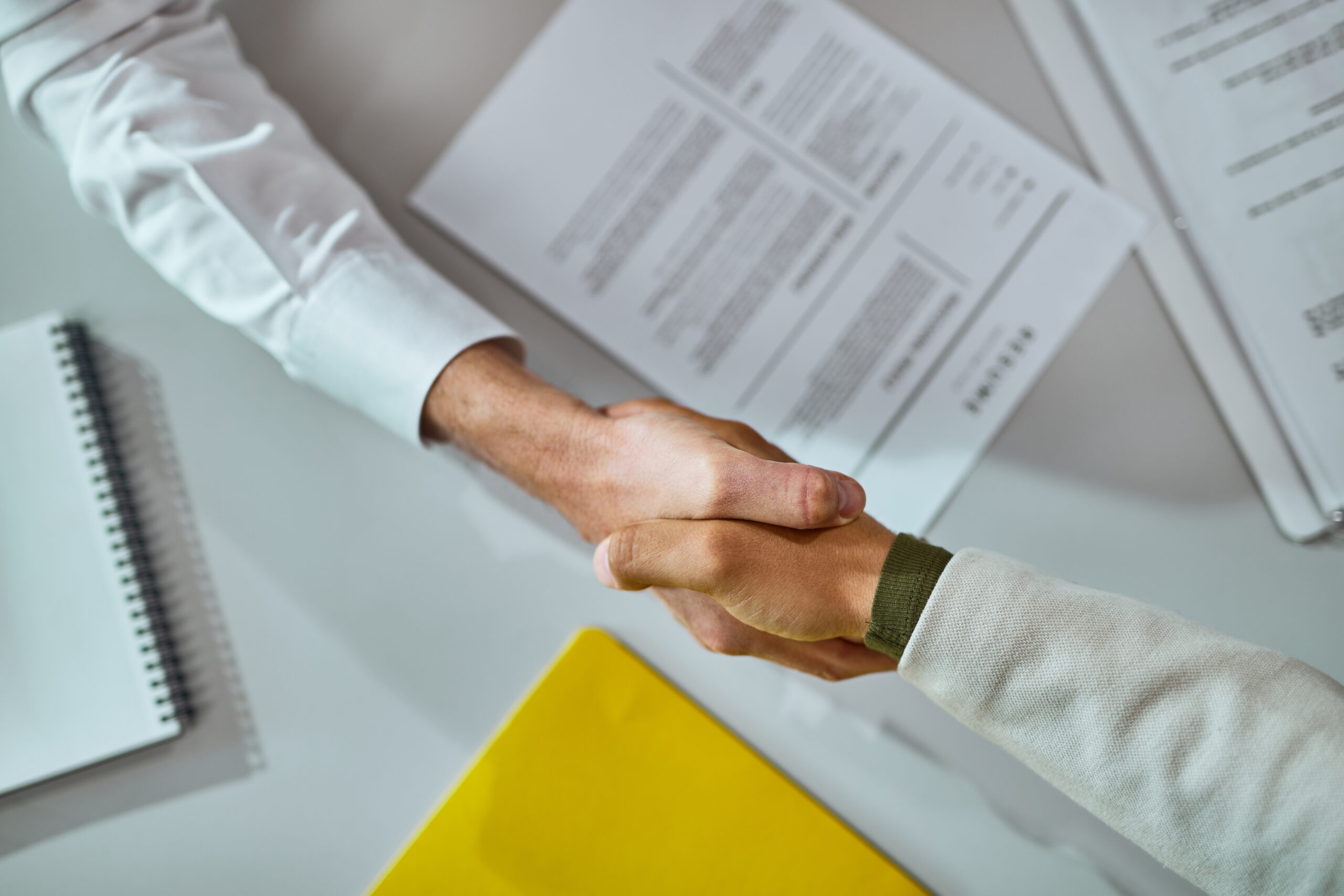 Close-up of businessmen shaking hands after successful agreement.